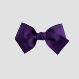 Purple bow on a white background