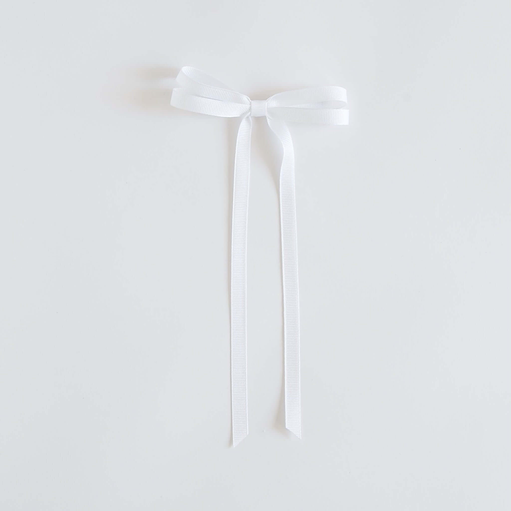 White ribbon bow on a white background