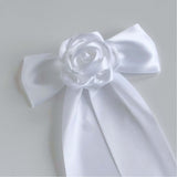 Close-up of white satin rose detail on Zoe bow hair clip