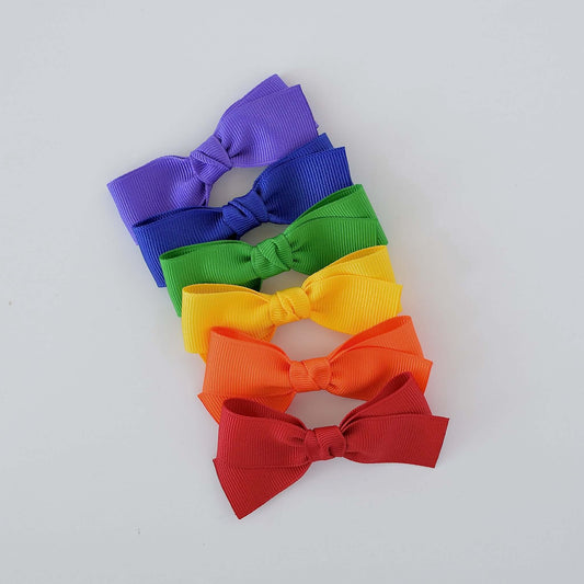 Colorful 3 inch grosgrain baby Kayla bow clips and headbands in rainbow colors.