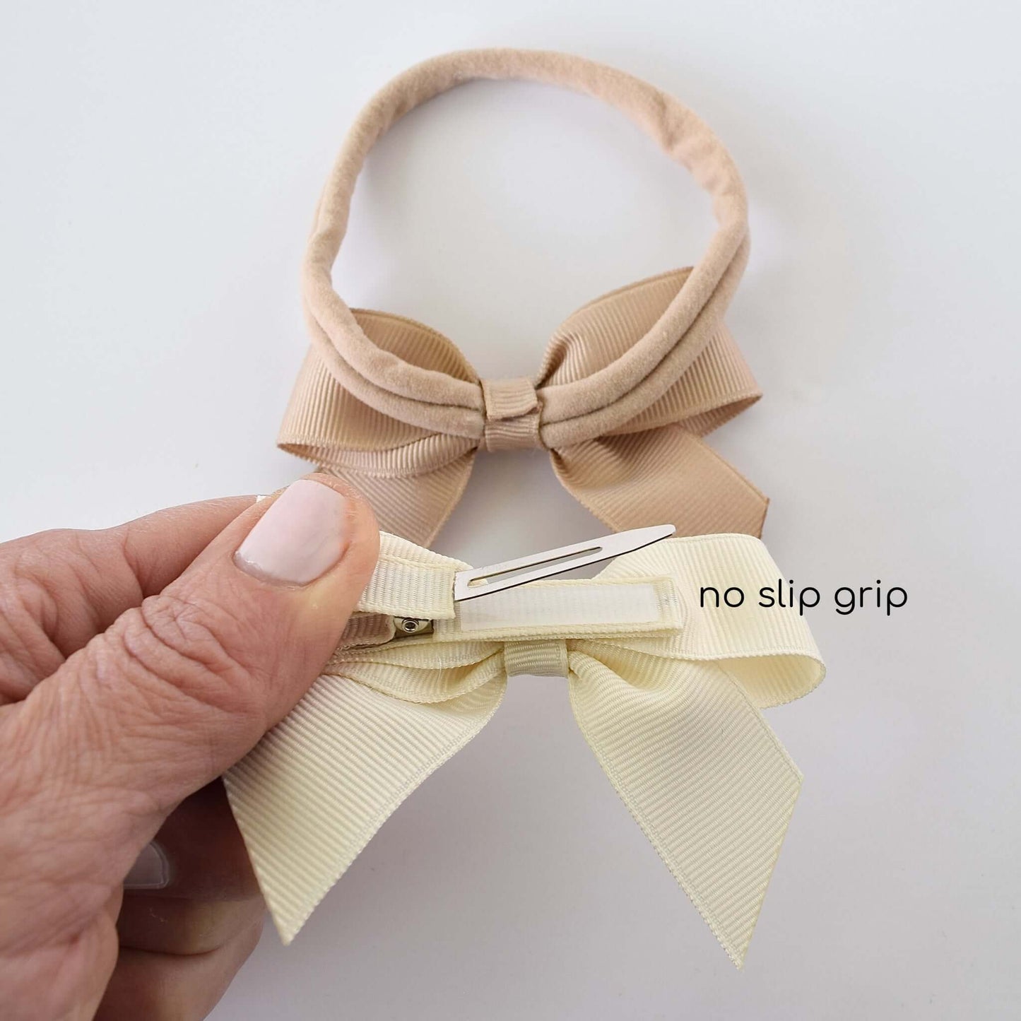 Neutral grosgrain sailor bow clip and headband for babies and toddlers, showcasing no-slip grip and durable materials