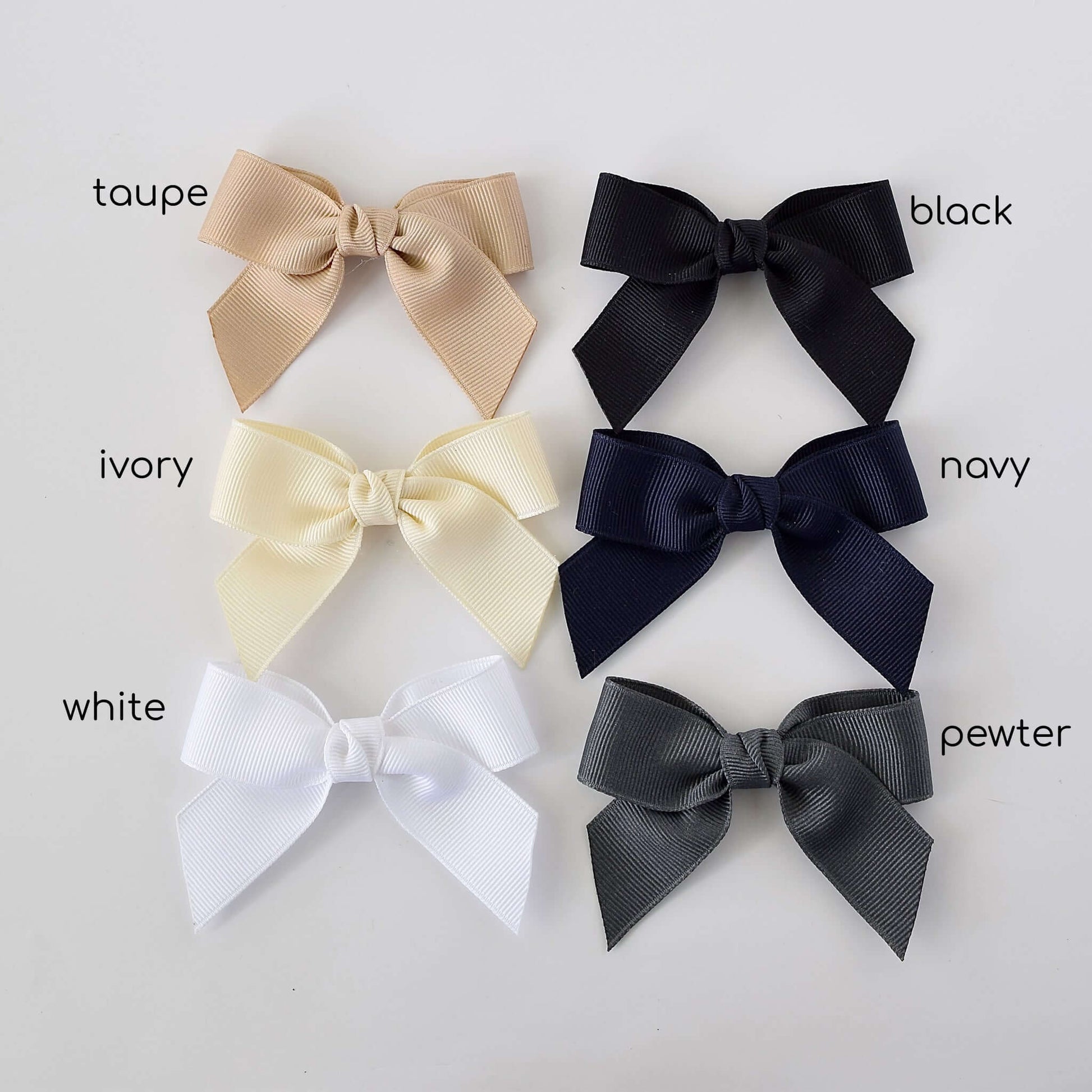 Six 3-inch grosgrain sailor bow clips in taupe, black, ivory, navy, white, and pewter colors arranged in two rows.