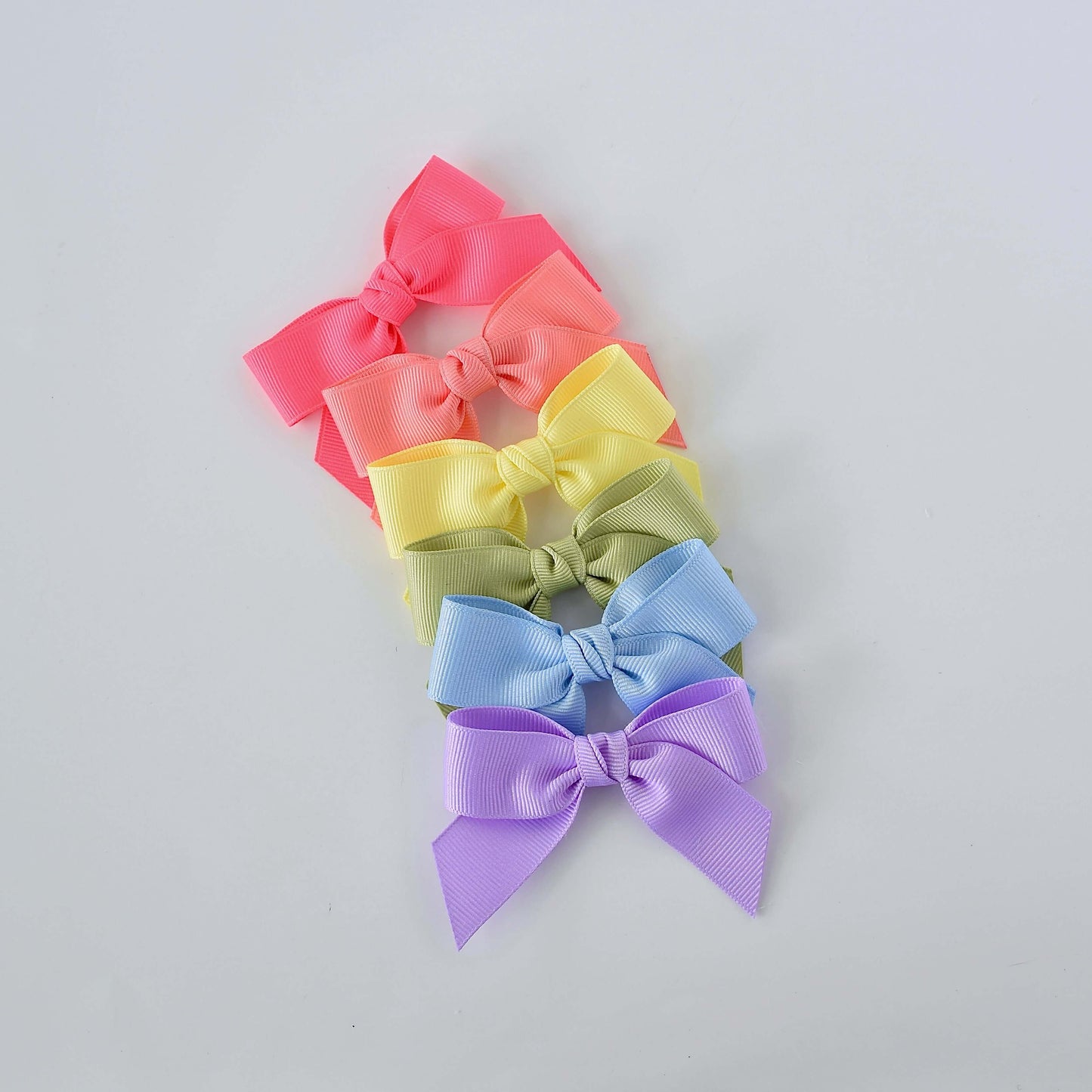 Pastel grosgrain Sailor bow clips and headbands in pink, orange, yellow, green, blue, and purple for newborns to young girls