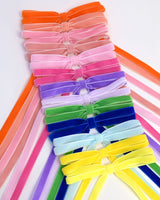 Olivia velvet hair bows for women in multiple colors with long ribbon tails on white background
