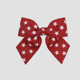 Red 4 inch sailor bow with white stars on a white background