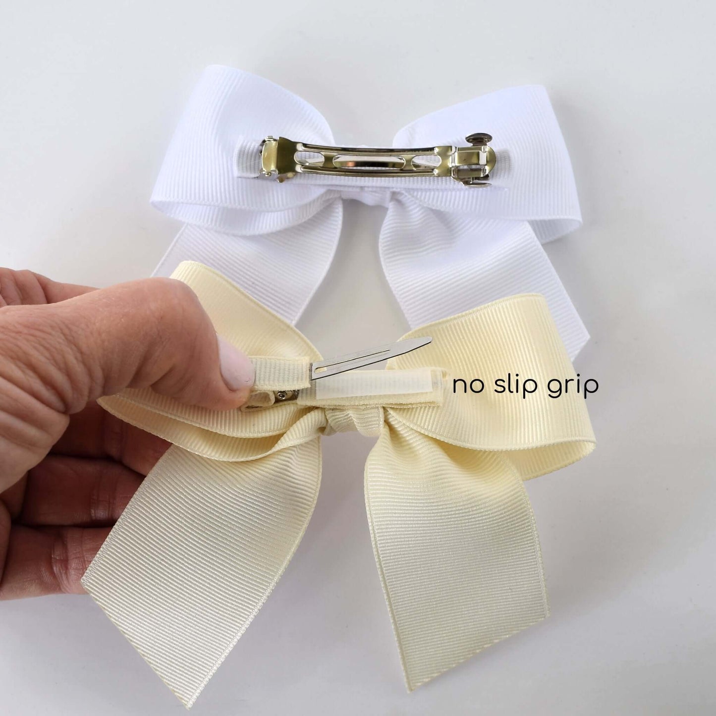 Handmade neutral grosgrain sailor bows with alligator clips and no-slip grip, in ivory and white, perfect for toddlers and girls