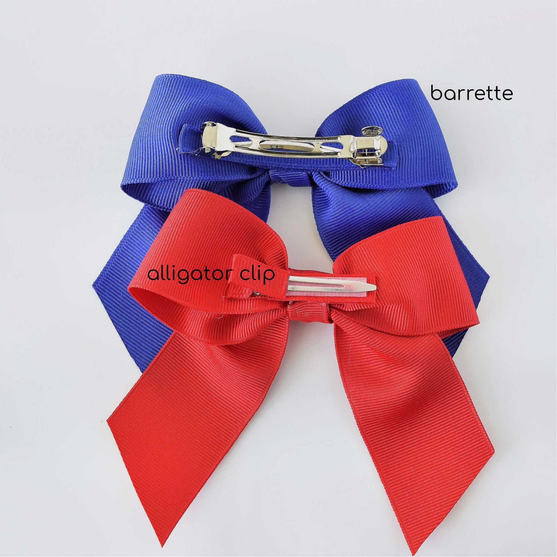 Red and blue grosgrain sailor bows with alligator clip and French barrette on white background.