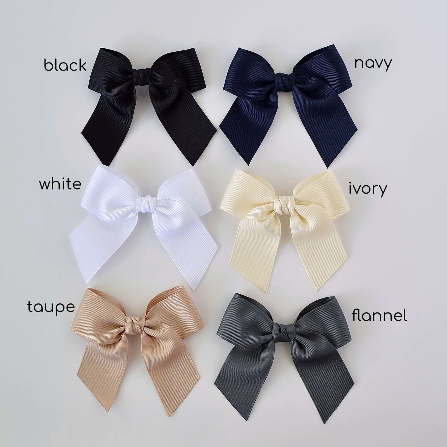 Six neutral 4-inch grosgrain sailor bows in black, navy, white, ivory, taupe, and flannel gray, displayed on a white background.