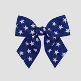 Royal blue 4 inch sailor bow with white stars on a white background