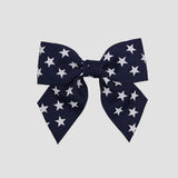 Navy blue 4 inch sailor bow with white stars on a white background