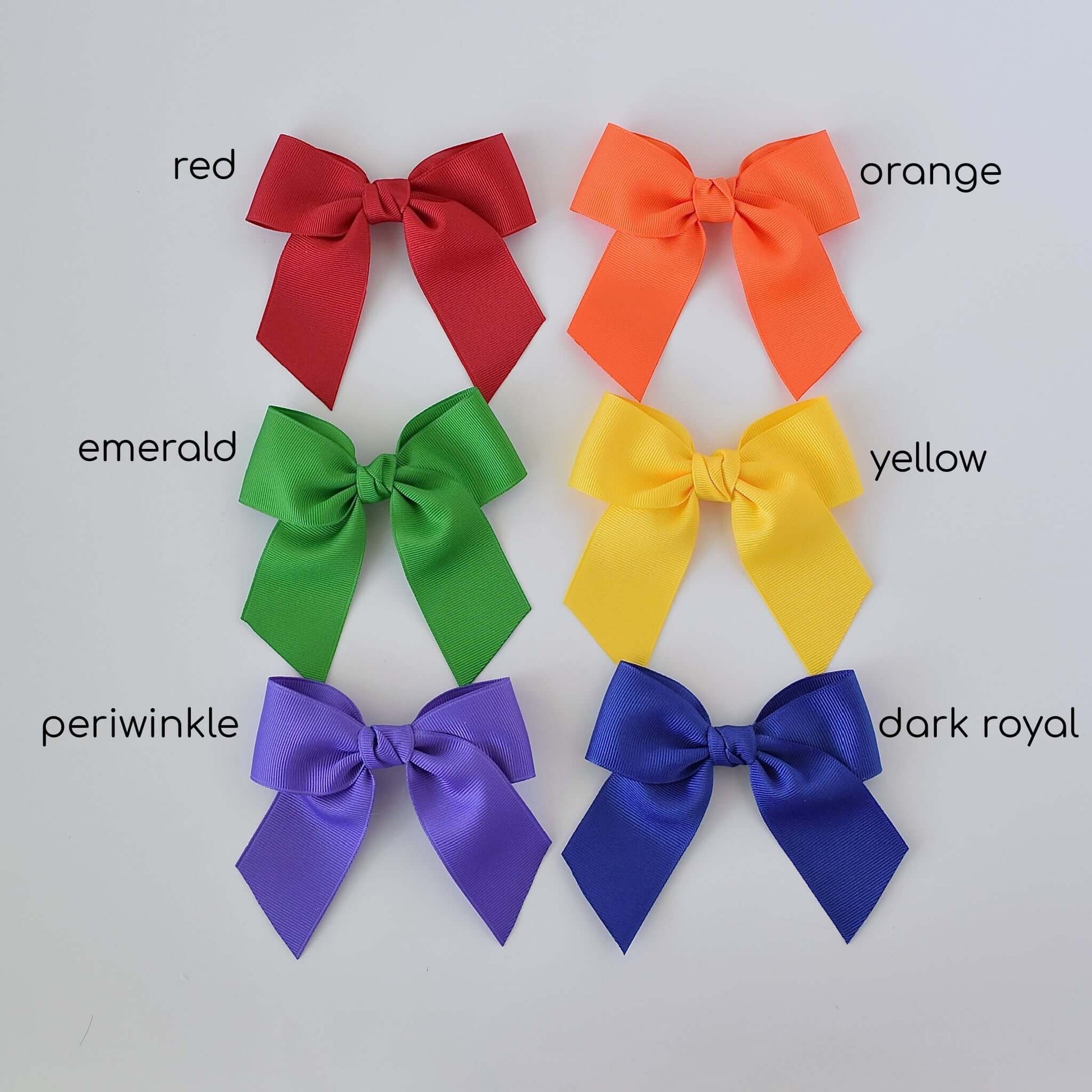 4 inch grosgrain sailor bows in rainbow colors – red, orange, emerald, yellow, periwinkle, dark royal – arranged in rows, perfect for toddlers and girls