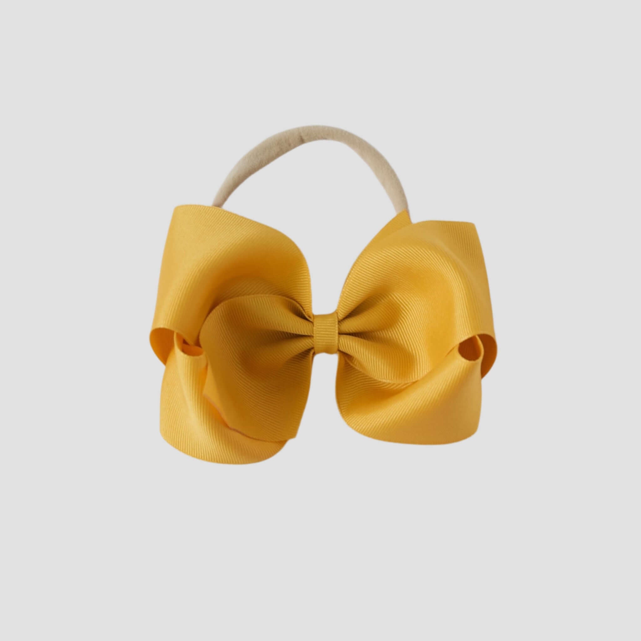 5 inch Grosgrain Penelope hair bow Headband in mustard yellow on a white background