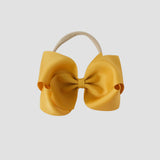 5 inch Grosgrain Penelope hair bow Headband in mustard yellow on a white background