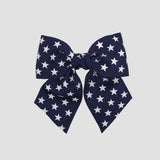 Navy blue 5 inch sailor bow with white star on a white background