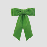 Mia velvet hair bow in apple green on a white background