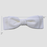 White Ave velvet bow showing measurement 2W x 6L  on a white background