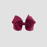 Azalea pink hair bow on a white background