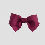 Azalea pink hair bow on a white background
