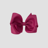 Azalea pink hair bow on a white background