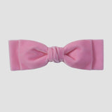 Blush pink velvet hair bow on a white background