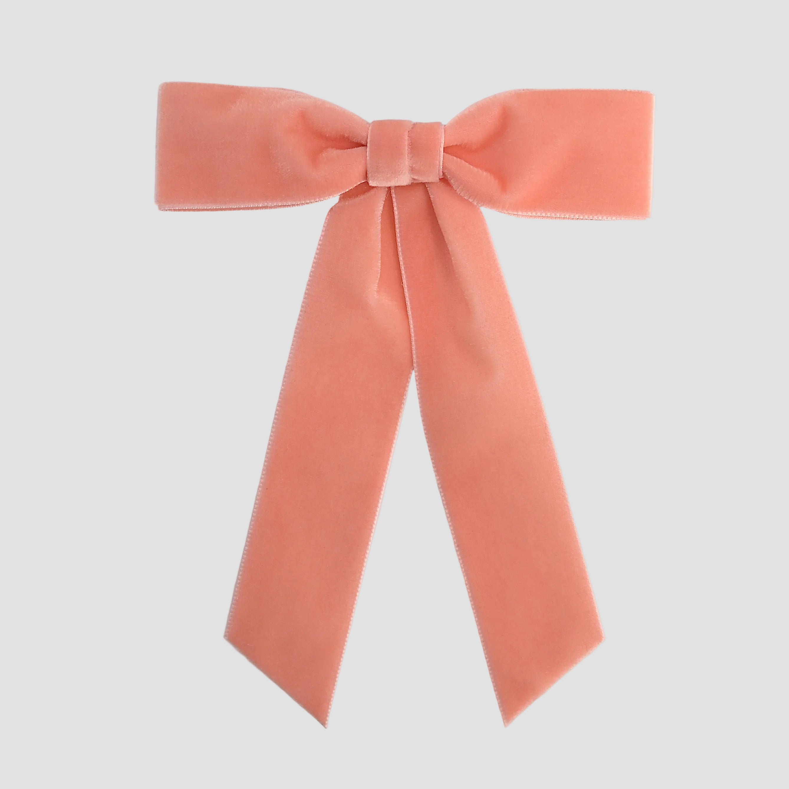 Coral orange Zoe petite velvet hair bow on a white background.