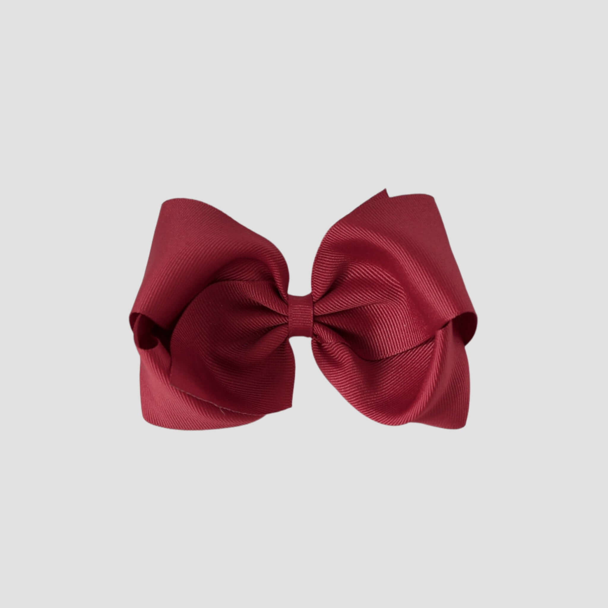 Cranberry red hair bow on a white background