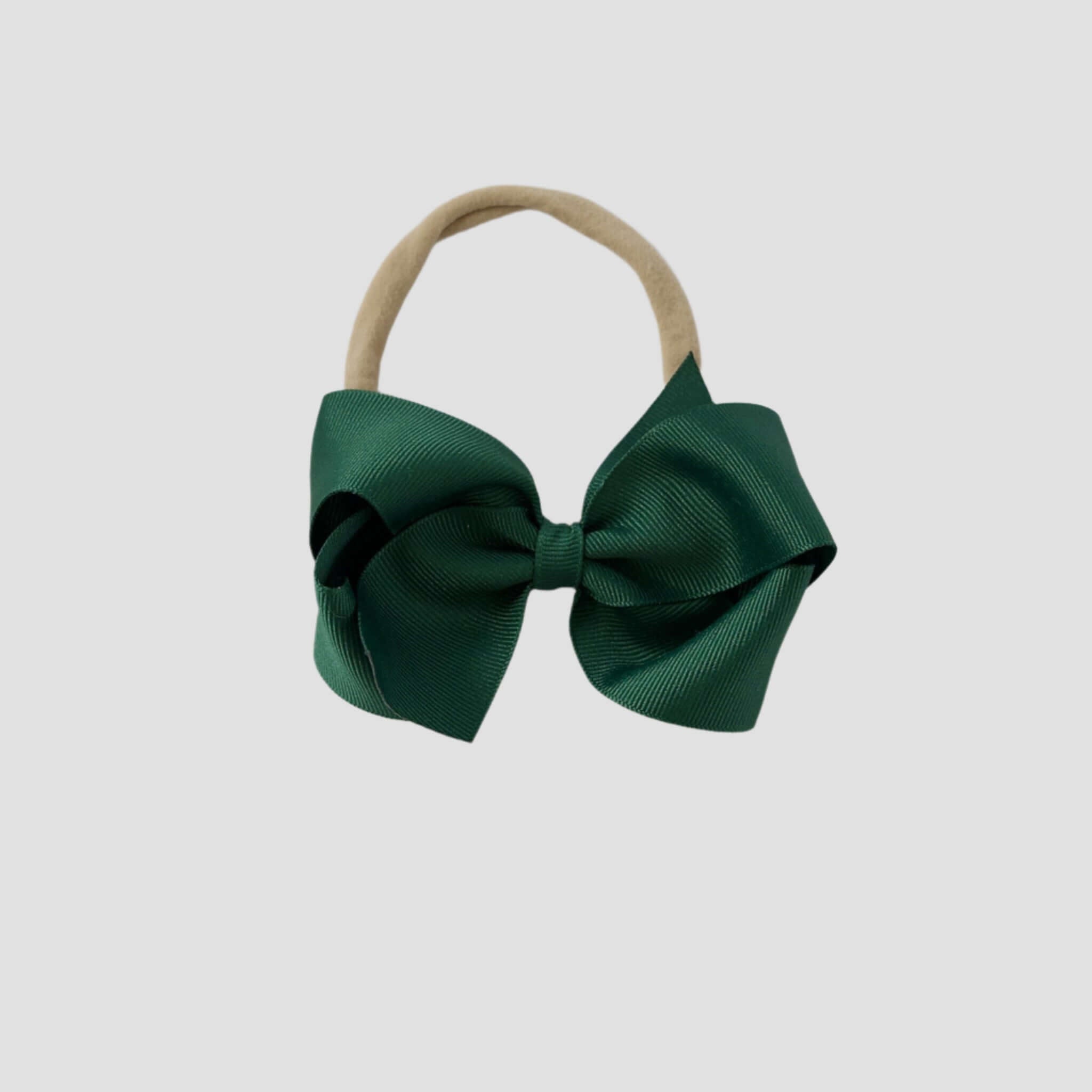Forest green grosgrain bow on a nude nylon headband