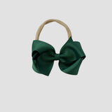 Forest green grosgrain bow on a nude nylon headband