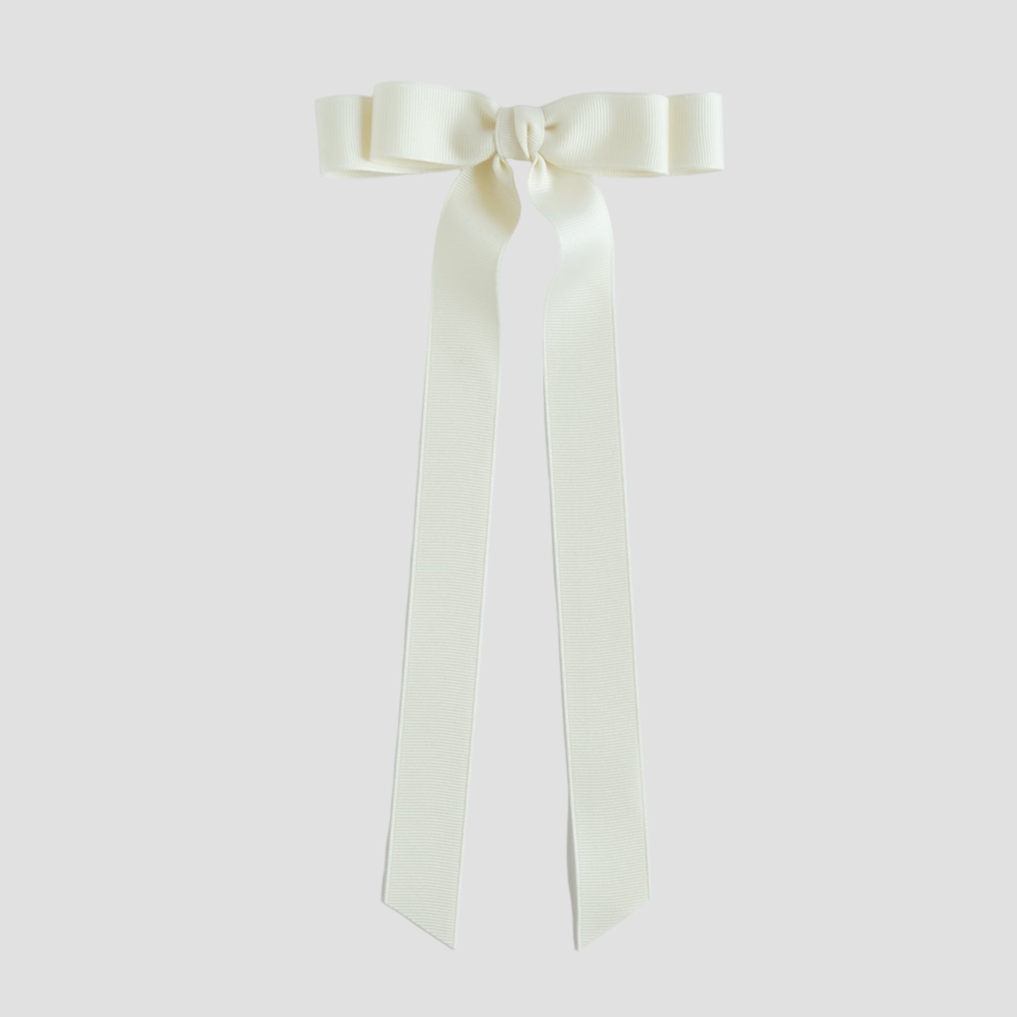 Ivory bow with long tails on a white background