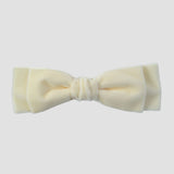 Ivory velvet hair bow on a white background