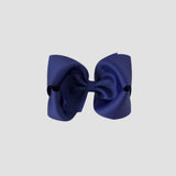 Light navy blue hair bow on a white background