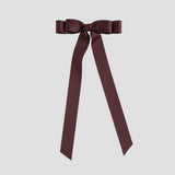 Maroon ribbon bow on a white background