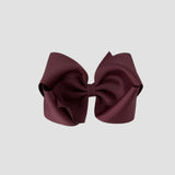 Maroon hair bow on a white background