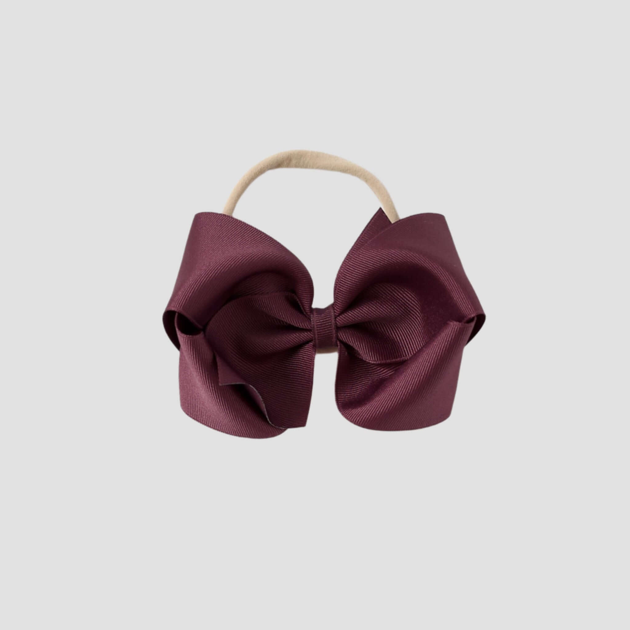 Maroon hair bow on a white background