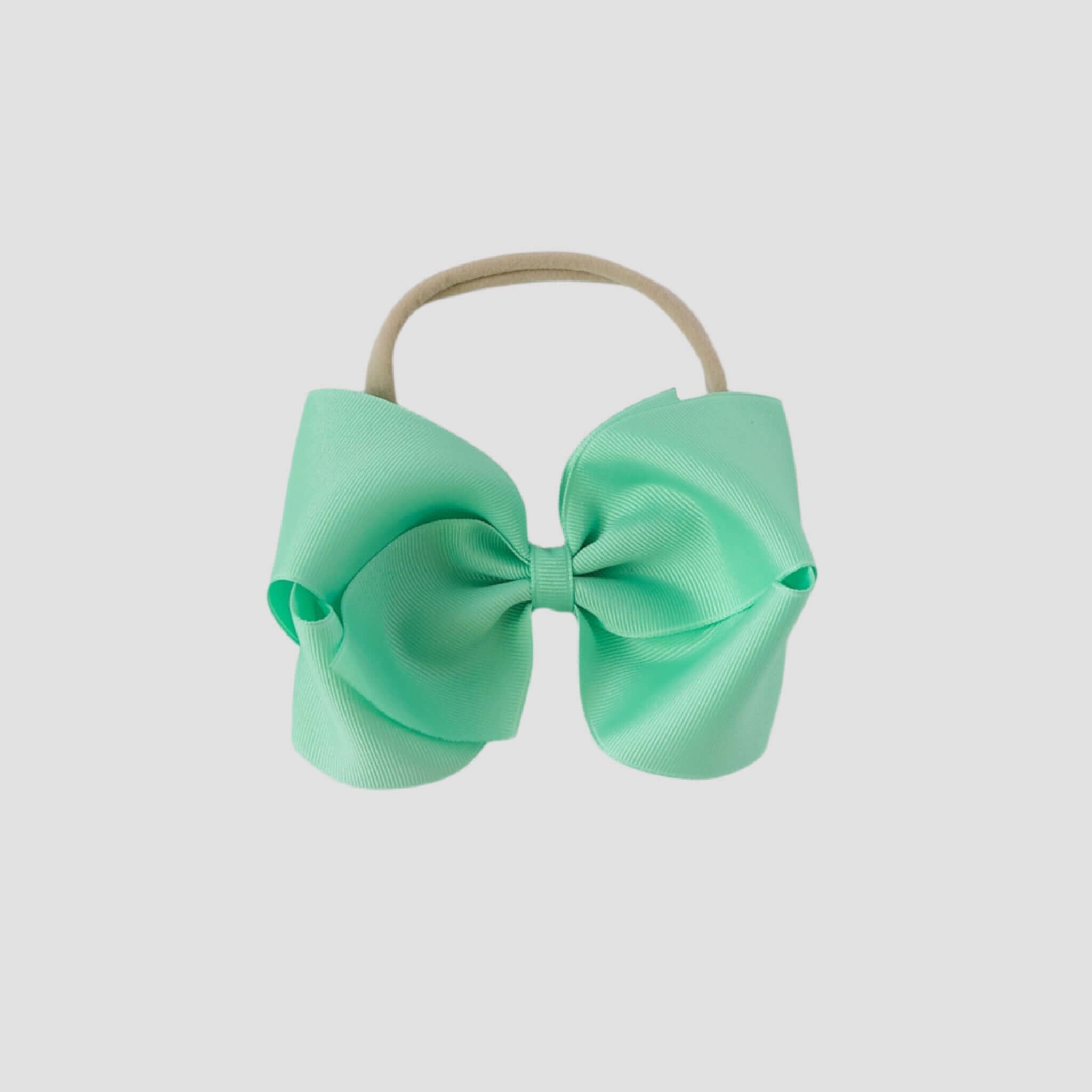 Mint green hair bow on a white background