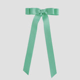 Mint green ribbon bow on a white background