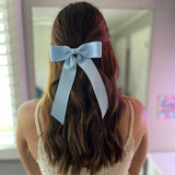Model wearing Zoe Petite bow in blue 
