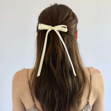 Olivia Picot Satin Bow accessory on a woman's hairstyle, featuring delicate picot edges and smooth satin ribbon.