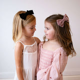 Girls wearing Kayal bow in headband and hair clip style.