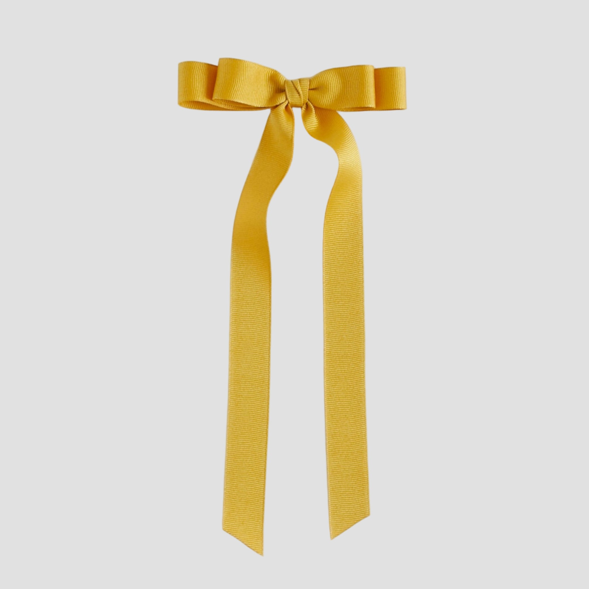 Mustard yellow grosgrain ribbon bow on a white background