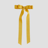 Mustard yellow grosgrain ribbon bow on a white background