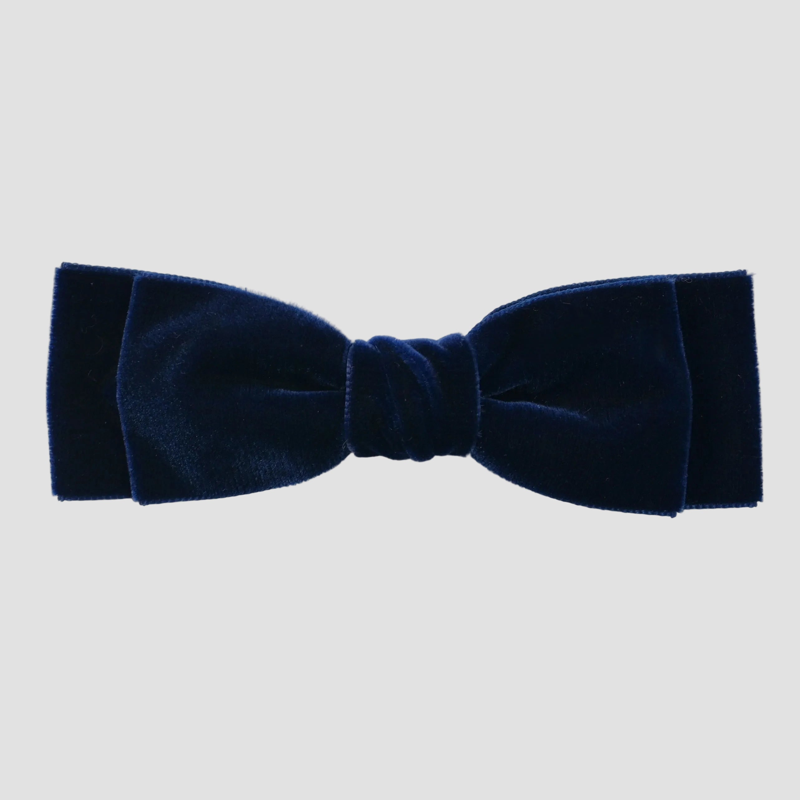 Navy blue velvet bow on a white  background