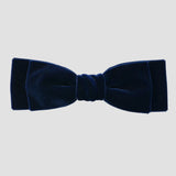 Navy blue velvet bow on a white  background