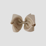 Oatmeal hair bow on a white background