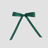 Forest green grosgrain ribbon bow on a white background