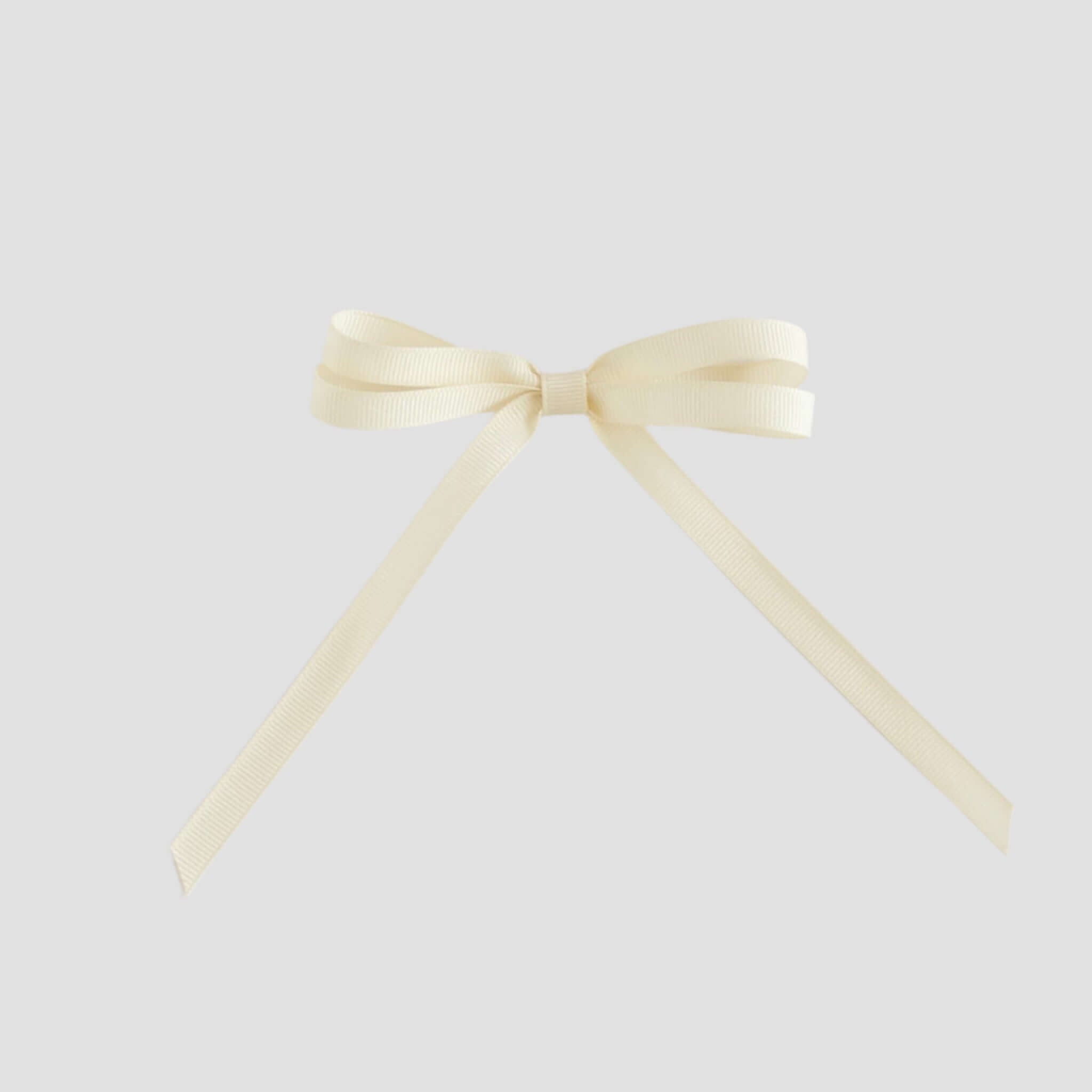 Ivory colored ribbon bow on a white background