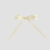 Ivory colored ribbon bow on a white background