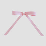 Light pink grosgrain ribbon bow on a white background