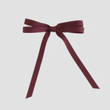 Maroon grosgrain ribbon bow on a white background