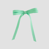 Mint green ribbon bow on a white background